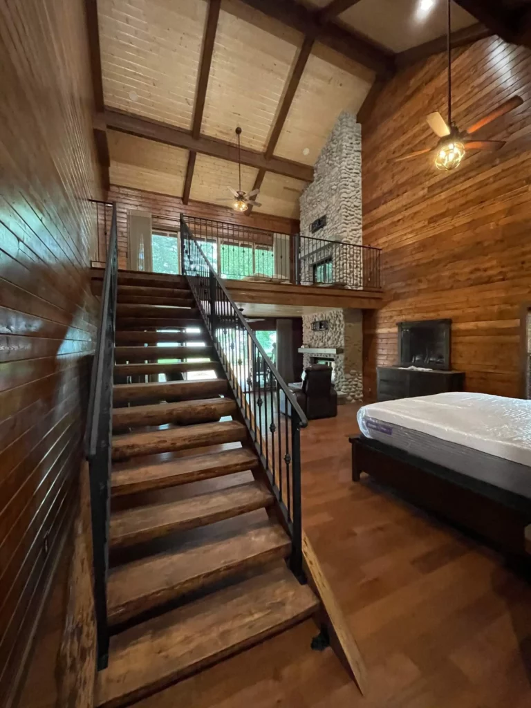 home cabin wood interior and stairs with rustic hanging ceiling fans
