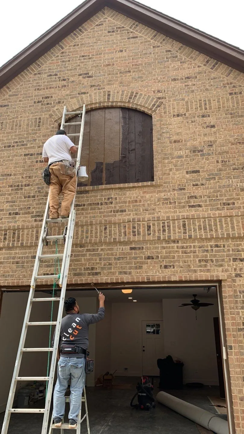 contractors on ladders painting home accents