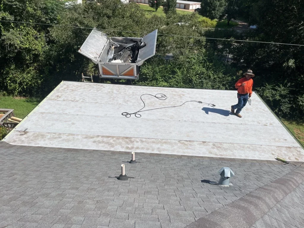 flat roof worker installing materials