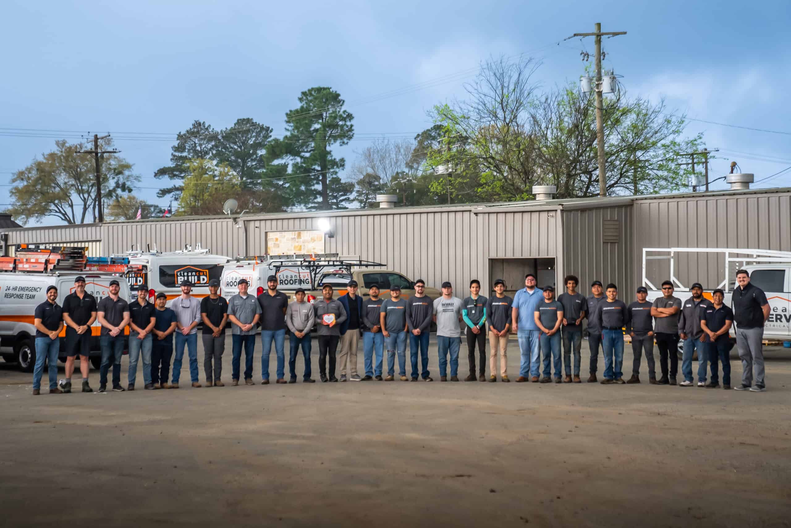 This image shows the Clean Cut staff standing for a photo outside