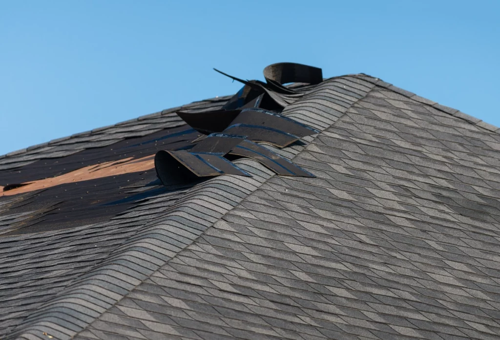 close up of missing shingles due to wind damage to roof