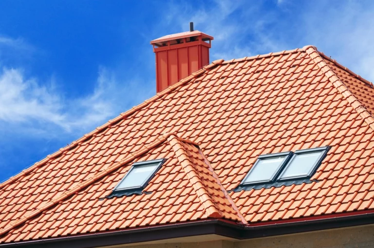 red roof tiles on house roof with windows