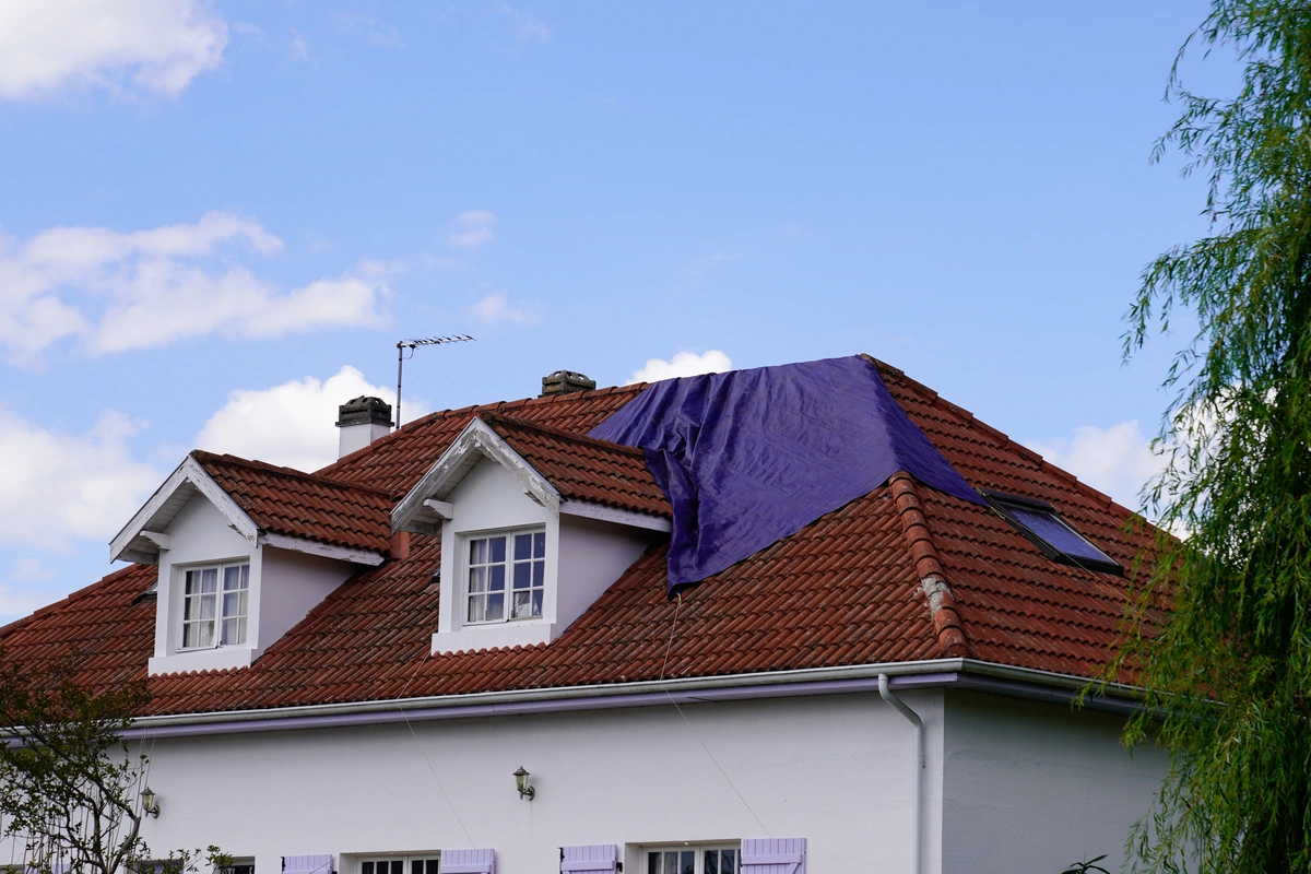 tile roof covered with tarp for leaking