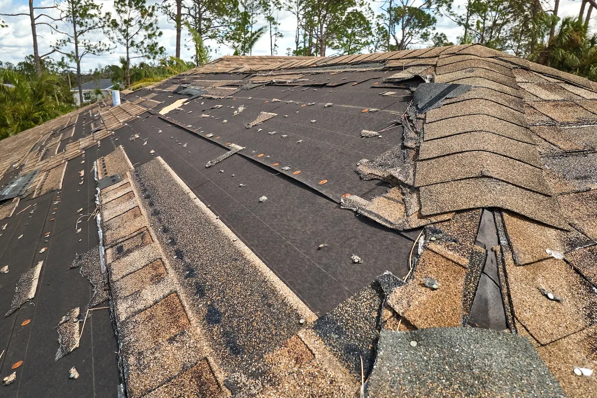 closeup of extreme roof storm damage in need of damage restoration