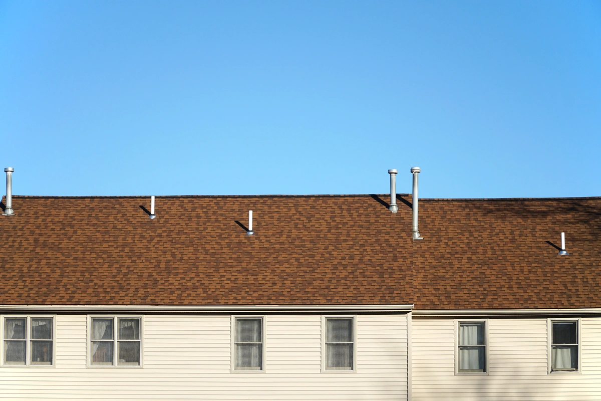 brown asphalt shingle roof on apartment roof