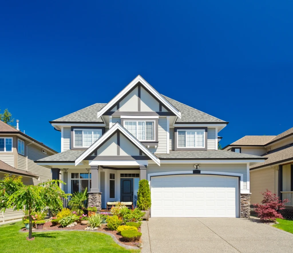 Front view of beautiful home with light siding and grey CertainTeed Shingle Color