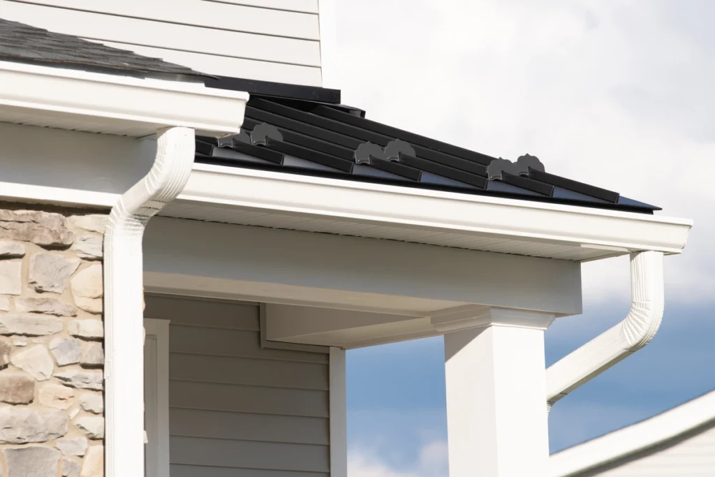 house eaves-white eaves on gray house with black roof