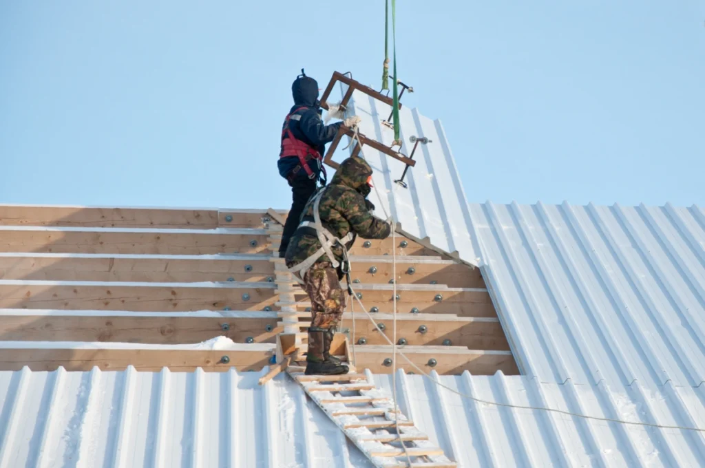 metal roof cost-team of two techs installing metal roofing panels