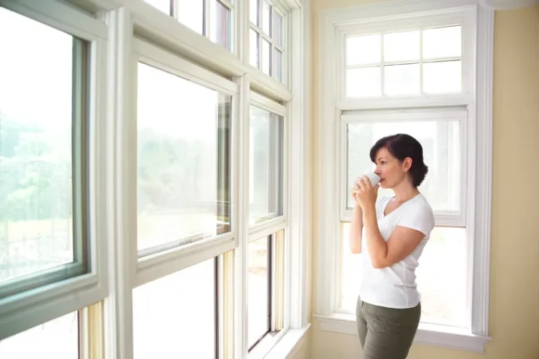 Homeowner in Tyler admiring new windows 