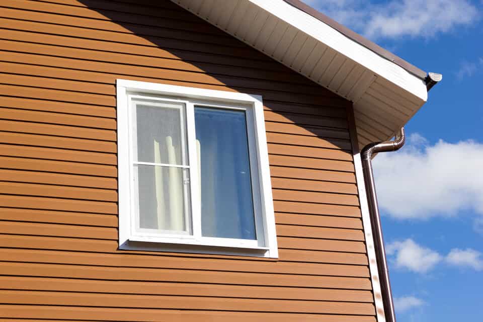 double hung window-brown sided house with double hung window