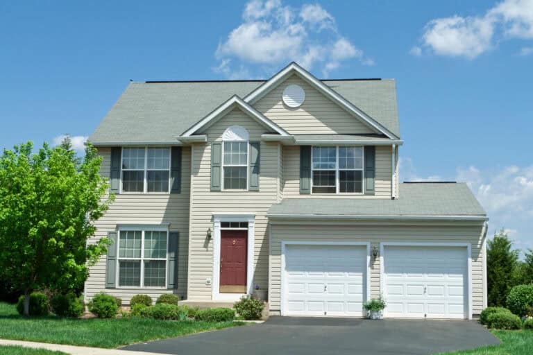 double hung window-cream sided house with red door and several double hung windows