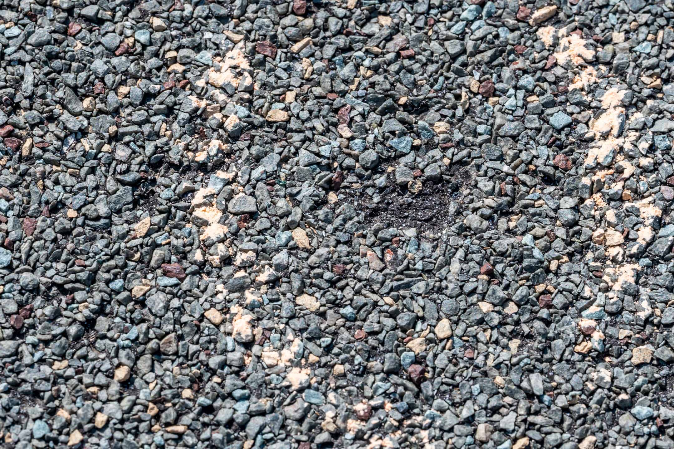 hail damage roof repair-micro image of a shingle with missing granules due to hail, marked by chalk