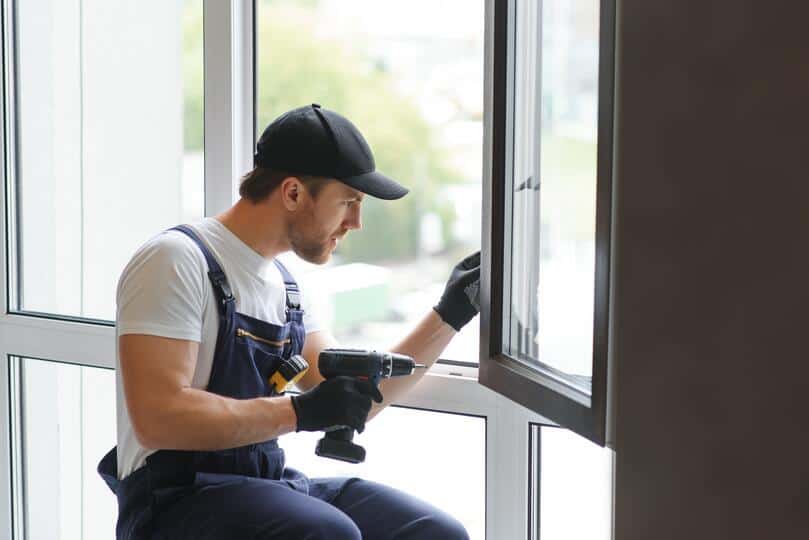 how to measure for replacement windows-technician using power tools to install a window