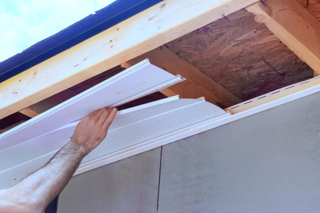 how to replace wood under roof overhang-technician repairing the fascia under the roof overhang