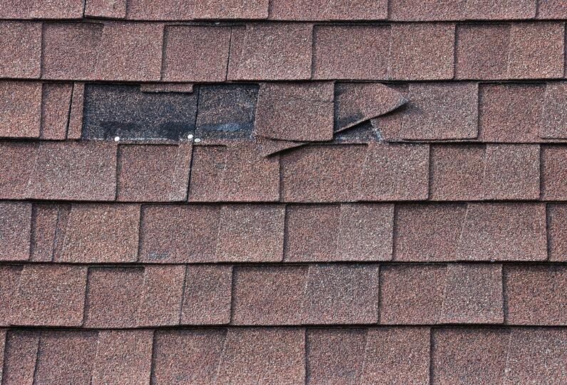 missing shingles-close up of reddish brown shingles with a section missing