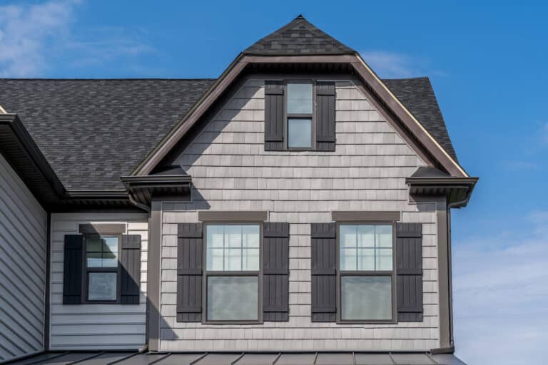 single hung window-gray shingled and sided house with several single hung windows with dark gray shutters