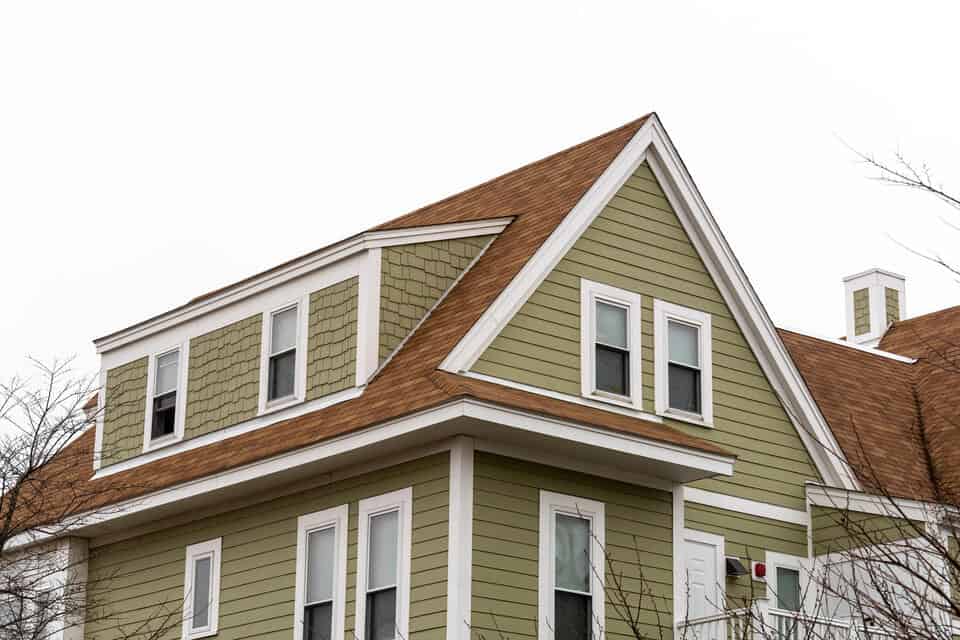 single hung window-green sided house with several single hung windows